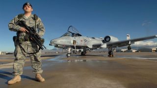 Senior Airman Mario Fajardo stands guard while on duty Jan. 25 at Davis-Monthan Air Force Base. 355th Security Force squadron is responsible for the worldwide force protection and security of seven flying squadrons and 4,400 tactical and stored aircraft on Davis-Monthan AFB worth more than 32.3 billion dollars. Airman Fajardo is with the 355th Security Forces Squadron. (U.S. Air Force photo/Airman 1st Class Melissa Copeland)